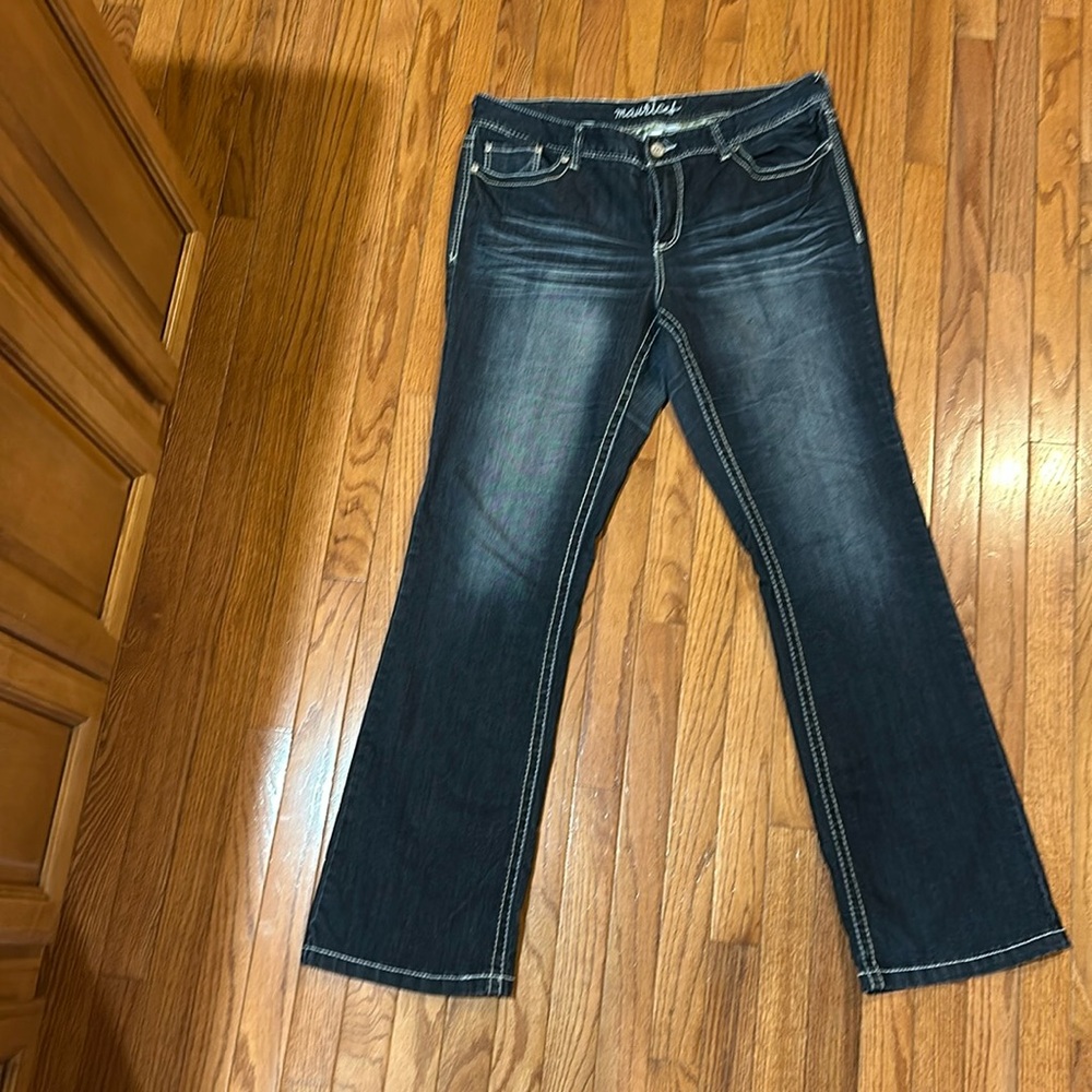 Dark distressed denim jeans with white stitching